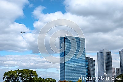 Skyscraper reflection cloud in downtown and airplane flying on b Stock Photo