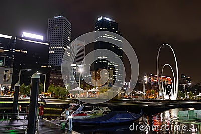 Skyscrapers at Elizabeth Quay in Perth, Western Australia with Spanda sculpture and speedboat Editorial Stock Photo