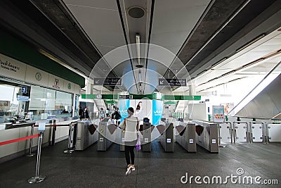 Skytrain passengers at entrance gate in BTS Bearing Station Editorial Stock Photo