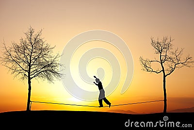 Slackliner in sunset Stock Photo