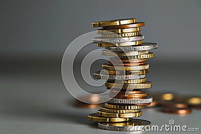 A slanted stack of coins. Euro coins stacked in a pile on the table, soft focus Stock Photo