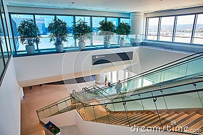 Slanted view of generic stairs descending into airport hallway leading to B Gates Stock Photo