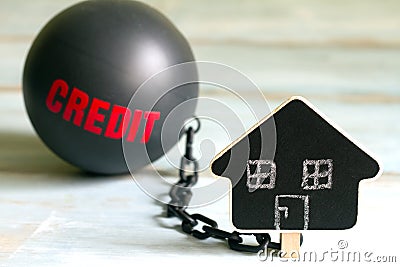Slave housing loan concept with credit iron ball and house symbol Stock Photo