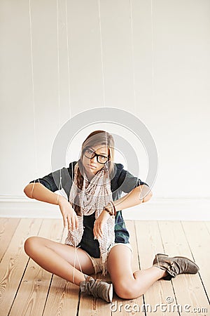 Slave to popular culture. A conceptual image of a pretty hipster being held by strings like a puppet. Stock Photo