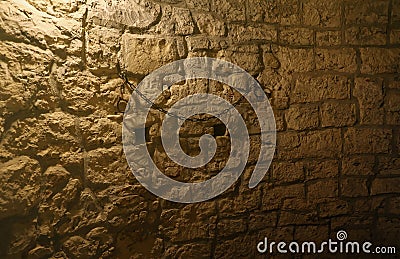 Slavery and bondage strong steel old shackles on stone wall in castle cellar Stock Photo