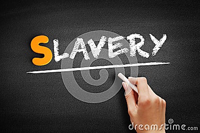 Slavery text on blackboard Stock Photo