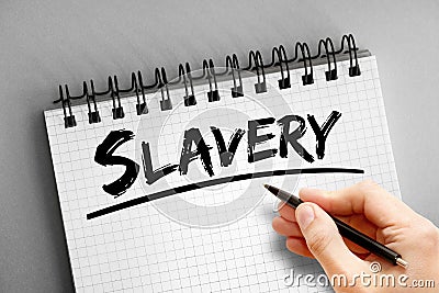 Slavery text on notepad, concept background Stock Photo