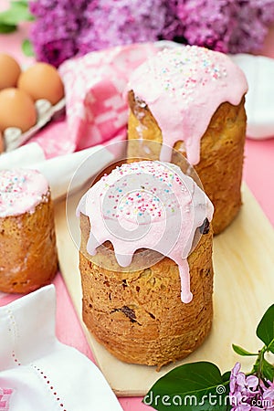 Slavic Orthodox Easter bread Kulich with raisins, nuts and pink icing Stock Photo