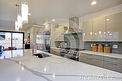 Sleek modern kitchen design with a long center island. Stock Photo