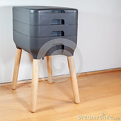 A sleek, modern looking indoor worm composter is the perfect solution for apartment living Stock Photo