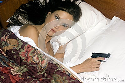 Sleep comes hard woman holds semi auto gun Stock Photo