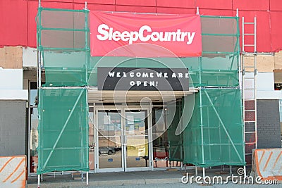 tor, canada - july 31, 2023: sleep country canada welcome we are open sign above store doors glass on canopy. p Editorial Stock Photo