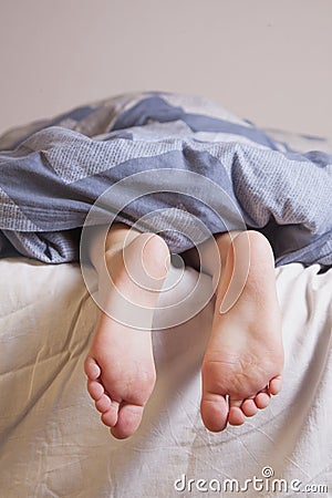 Sleep and relax concept. Beautiful groomed bare feet of cute little child girl Stock Photo