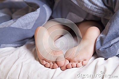 Sleep and relax concept. Beautiful groomed bare feet of cute little child girl. Sleep and rest concept Stock Photo