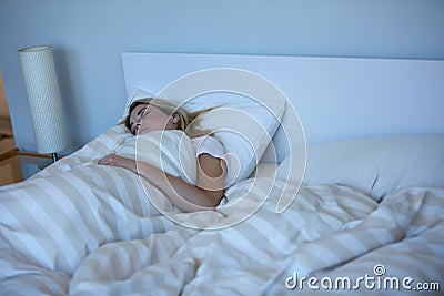 Sleep solves everything. a beautiful woman sleeping peacefully in her bed. Stock Photo