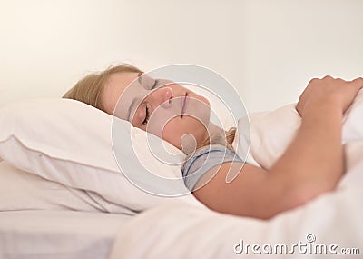 Sleep solves everything. a young woman sleeping peacefully in her bed. Stock Photo