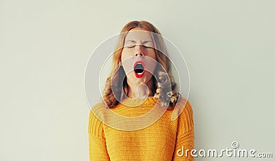 Sleepiness. Young tired woman yawns opens her mouth wide Stock Photo