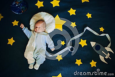 Sleeping baby boy astronaut on a background of the sky Stock Photo