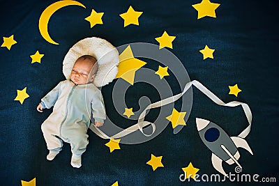 Sleeping baby boy on a background of the starry sky Stock Photo