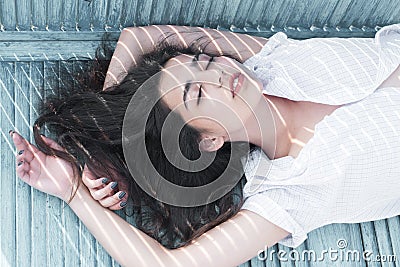 Sleeping beauty. Woman with long hair sleep on bench. Arabian woman relax with closed eyes, pure look. Total relaxation Stock Photo
