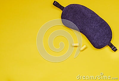 Sleeping eye mask, ear plugs on colourful background. Stock Photo