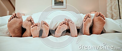 Sleeping, feet and family in bed relax, peaceful and enjoying. a nap in their home together. Foot, sleep and children Stock Photo