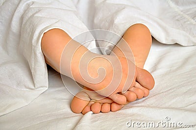 Sleeping girl feet Stock Photo