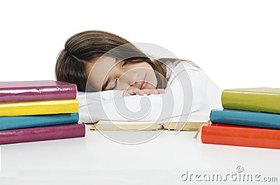 Sleeping while learning - tired little girl sleeping on desk. Stock Photo