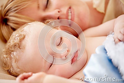 Sleeping, mom and calm baby in bed together with peace, happiness and love for infant in morning nap. Mother, cuddle and Stock Photo