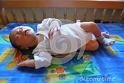 Sleeping newborn baby boy in bedstead Stock Photo