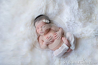 Sleeping Newborn Baby Girl on White Sheepskin Rug Stock Photo