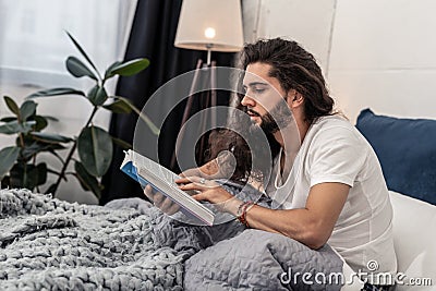 Nice handsome man reading his favourite book Stock Photo