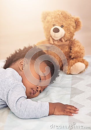 Sleeping, teddy bear and dreaming with baby in bedroom for carefree, development and innocence. Cute, relax and Stock Photo