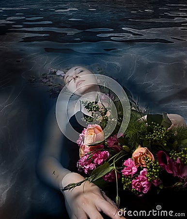 Sleeping woman in a dark water of a river Stock Photo