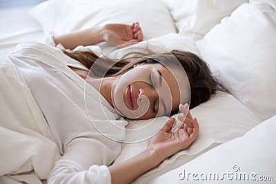 Sleeping woman enjoying rest in cozy bed in the morning Stock Photo