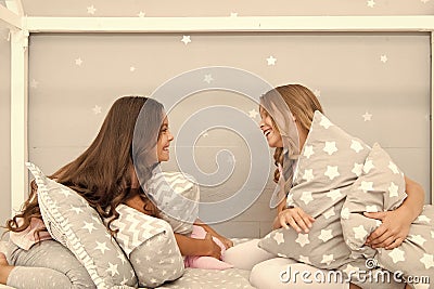 Sleepover time for pillow fight. Girls sleepover party ideas. Soulmates girls having fun sleepover party. Girls happy Stock Photo