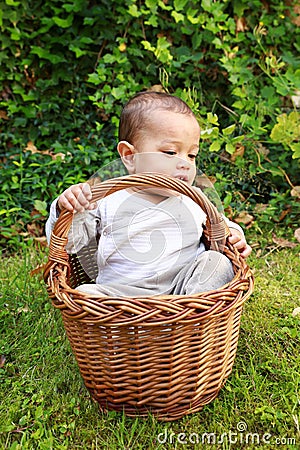 Sleepy baby boy in wicked basket Stock Photo