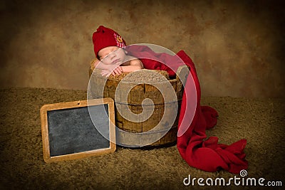 Sleepy baby with name plate Stock Photo