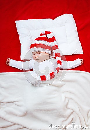 Sleepy baby on red blanket Stock Photo