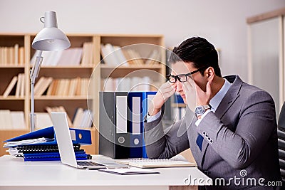 The sleepy businessman working in office Stock Photo