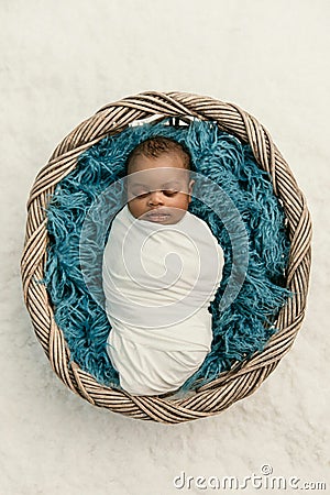Sleepy swaddled African-American newborn baby boy Stock Photo
