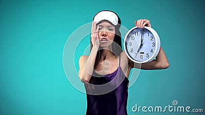 Sleepy woman cant wake up at 7 oclock, bad sleep conditions, biological rhythm Stock Photo