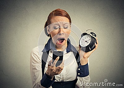 Sleepy woman with mobile phone and alarm clock Stock Photo