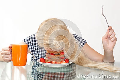 Sleepy young woman had breakfast and put her head in a plate, fell asleep in a plate. The concept of early morning, heavy morning. Stock Photo