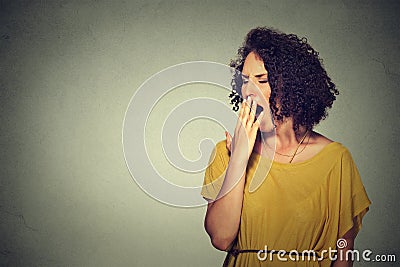 Sleepy young woman with wide open mouth yawning eyes closed looking bored Stock Photo