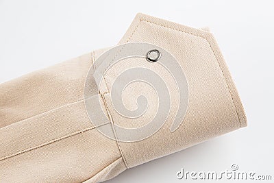 Sleeve detail, beige cotton fabric cuff, button closure Stock Photo