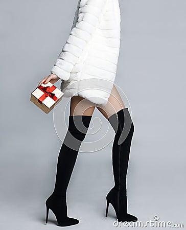 Slender female legs in boots stockings Stock Photo