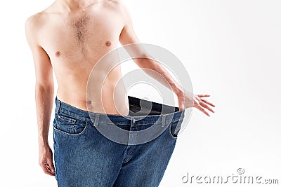 Slender guy showing result of his diet Stock Photo