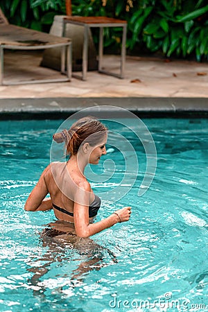 Slender tanned woman swimming at the pool. Rest and spa. Close up Stock Photo