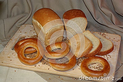 Slice bread and wheat grain on cutting board Stock Photo